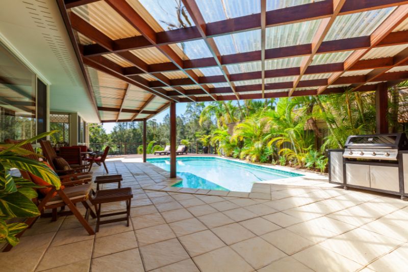 pool deck with an outdoor kitchen and lounge area
