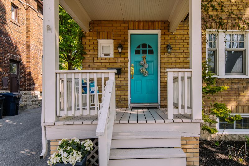 Small verandah with a chair and a blue door at an Ipswich home